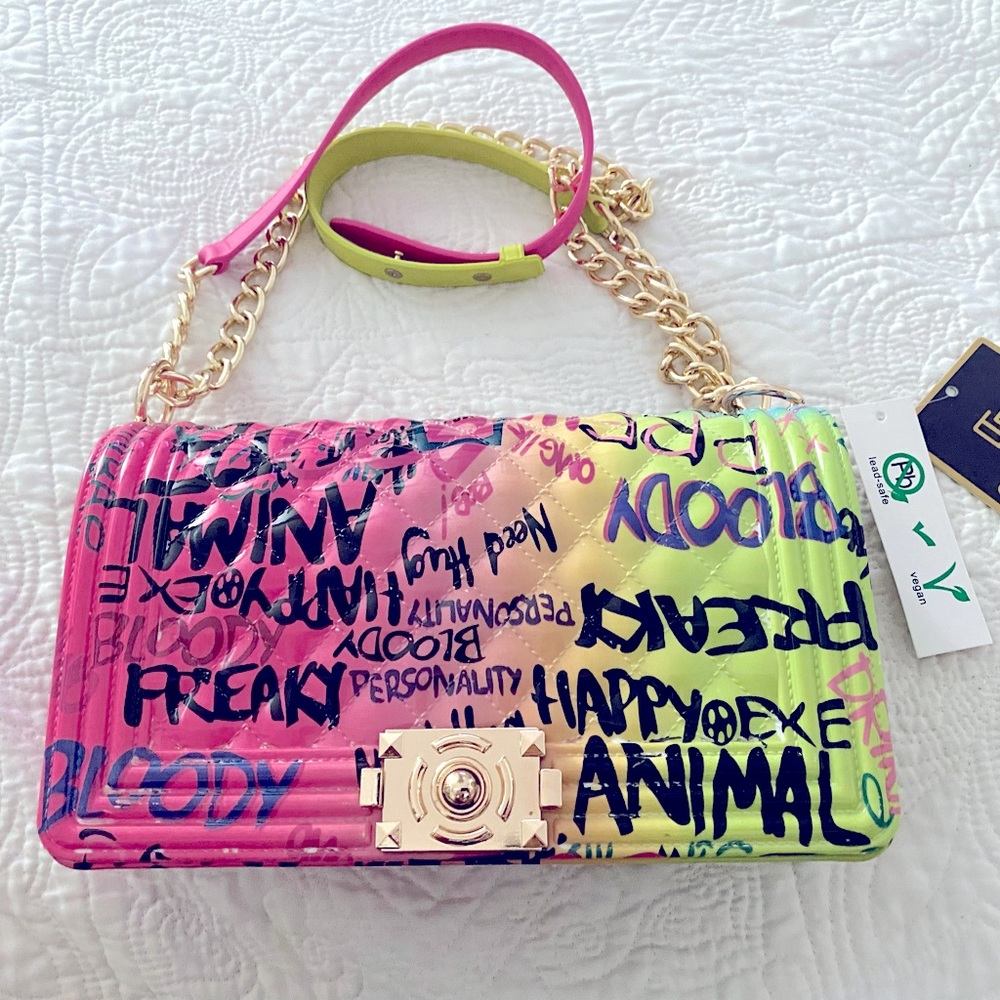 New Caleesa graffiti jelly fold over flap crossbody bag with gold tone hardware.